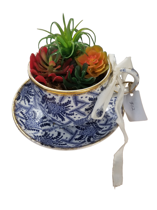 Cup and saucer with faux succulents