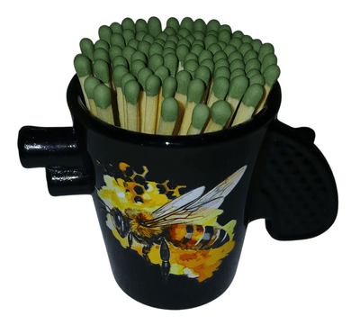 Black glass shot glass with handle - The Creative Shed - The Creative Shed - Black mug with a bee design filled with green matches on a white background - 