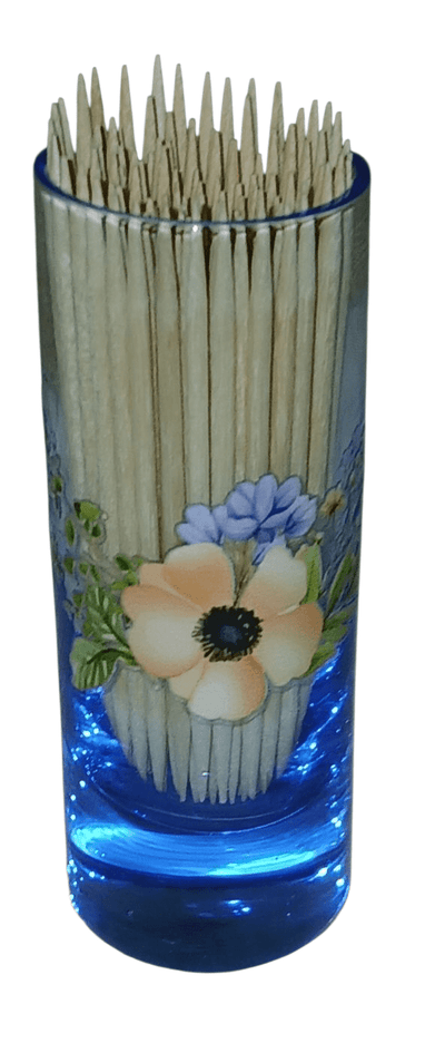 Blue glass shot glass with toothpicks - The Creative Shed - The Creative Shed - Tall blue container with floral design filled with toothpicks on a white background - 