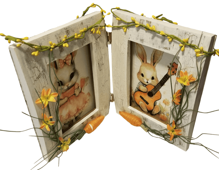 Double Rabbit Picture Frame - The Creative Shed - The Creative Shed - A double rabbit picture frame with two images of rabbits, one with a guitar. The frame is decorated with yellow flowers and has a rustic white background. - 