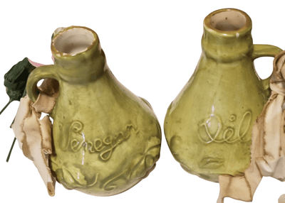 Green Oil and Vinegar containers - The Creative Shed - Decor - The Creative Shed - Two ceramic oil and vinegar containers with green glaze, one marked 'Vinegar' and the other 'Oil', lacking tops, and appearing to be used as vases. - 