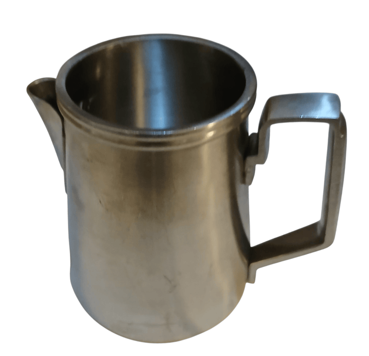 Metal creamer - The Creative Shed - The Creative Shed - Stainless steel pitcher with handle on a white background - 