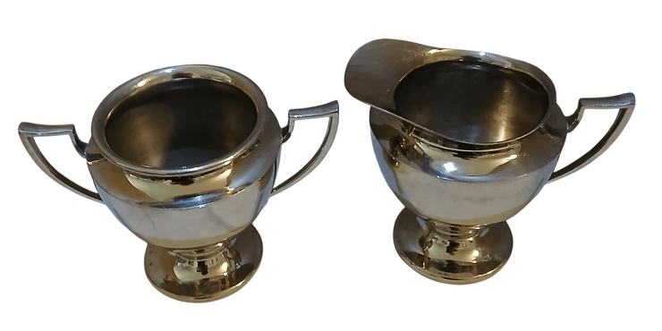 Metal creamer and sugar containers - The Creative Shed - The Creative Shed - Two silver Metal creamer and sugar containers with handles on a white background - 