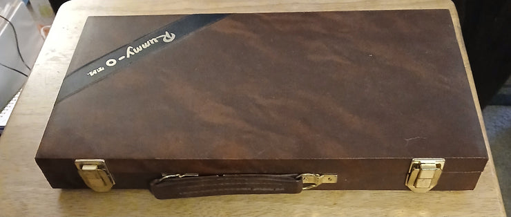 Rummy - o tile travel game - The Creative Shed - Travel games - The Creative Shed - Rummy - o tile travel game - Brown leather case with gold hardware on a wooden surface - 