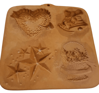 Terra Cotta Cookie Mold/Holidays - The Creative Shed - The Creative Shed - A brown terracotta cookie mold featuring various holiday - themed shapes such as a star and a Christmas tree. - 