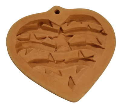 Terra Cotta Cookie Mold/Patriotic Heart - The Creative Shed - The Creative Shed - A terracotta cookie mold in the shape of a heart with indented details resembling a patriotic star pattern. - 